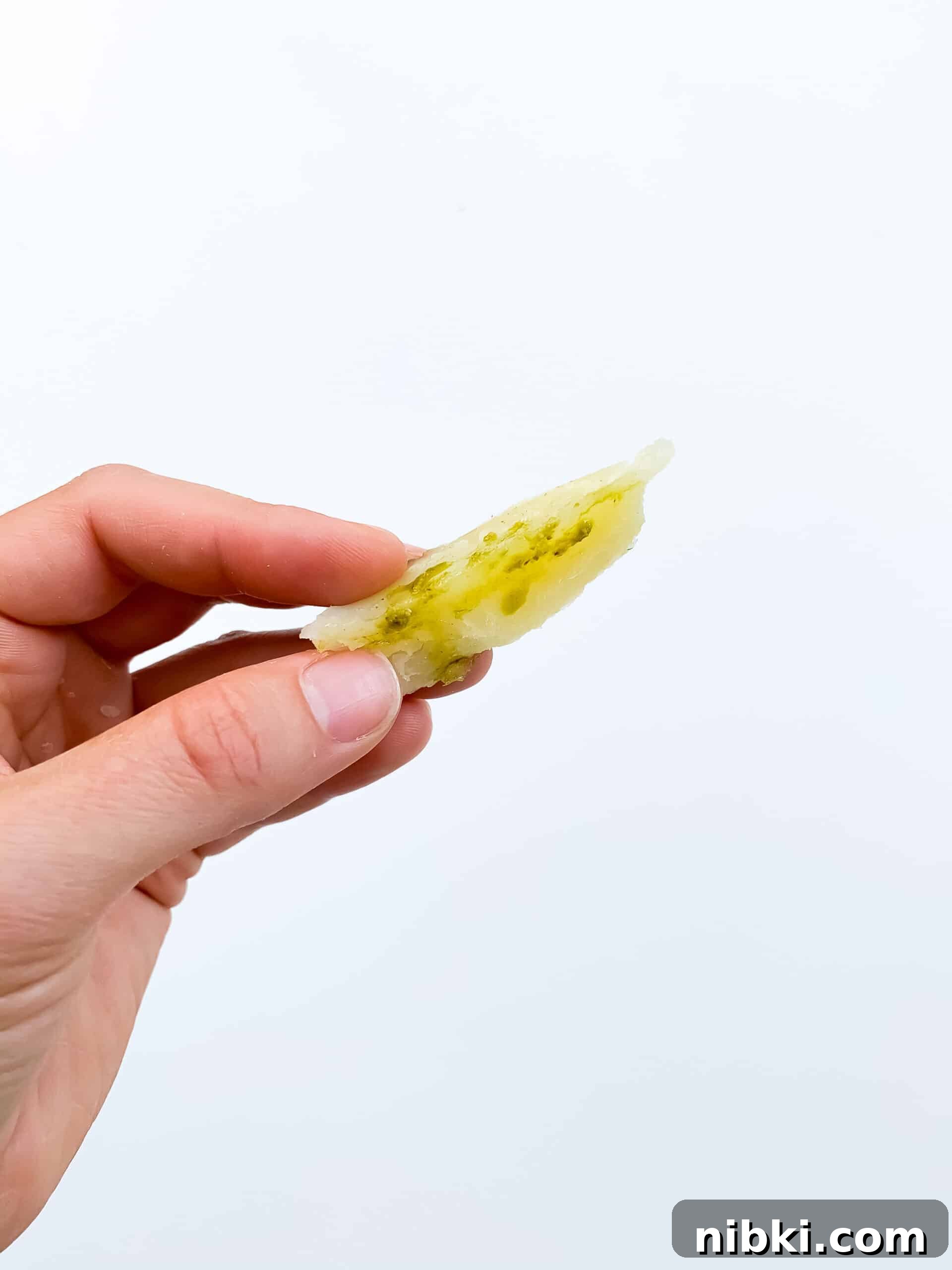What to Feed an 8-Month-Old (and 9-10 Month Babies) 3 baked potato wedge with olive oil and pesto for baby with white background