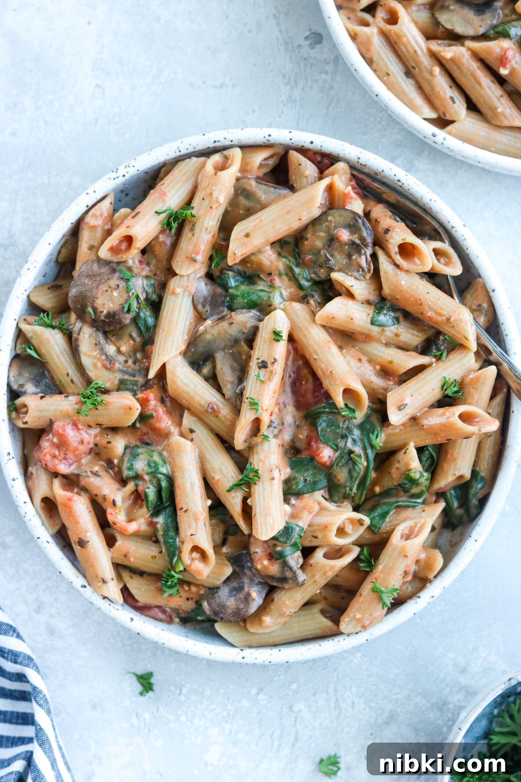 Creamy Tomato Penne Pasta made in the Instant Pot on a white bowl pasta made in the Instant Pot on a white bowl