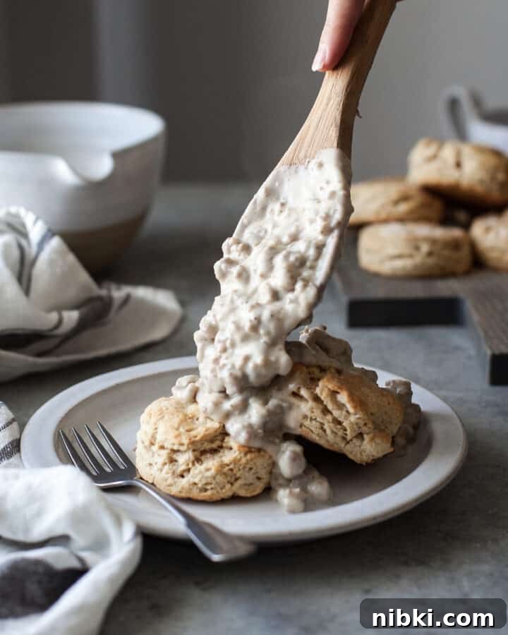 healthy biscuits and gravy on a white plate with a fork