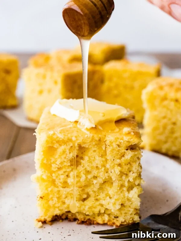 Creamy Avocado Coleslaw Recipe for Summer BBQs 10 Honey pouring onto a slice of sweet cornbread with butter.