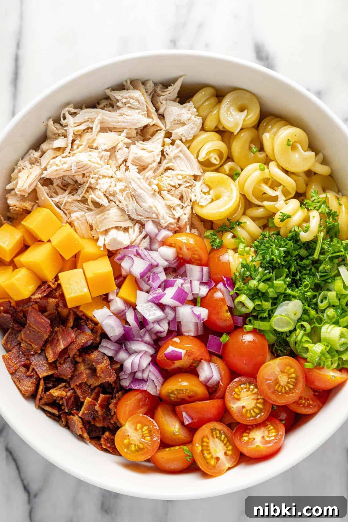 Creamy Chicken Bacon Ranch Pasta Salad Recipe 4 Bowl filled with ingredients to make chicken pasta salad.
