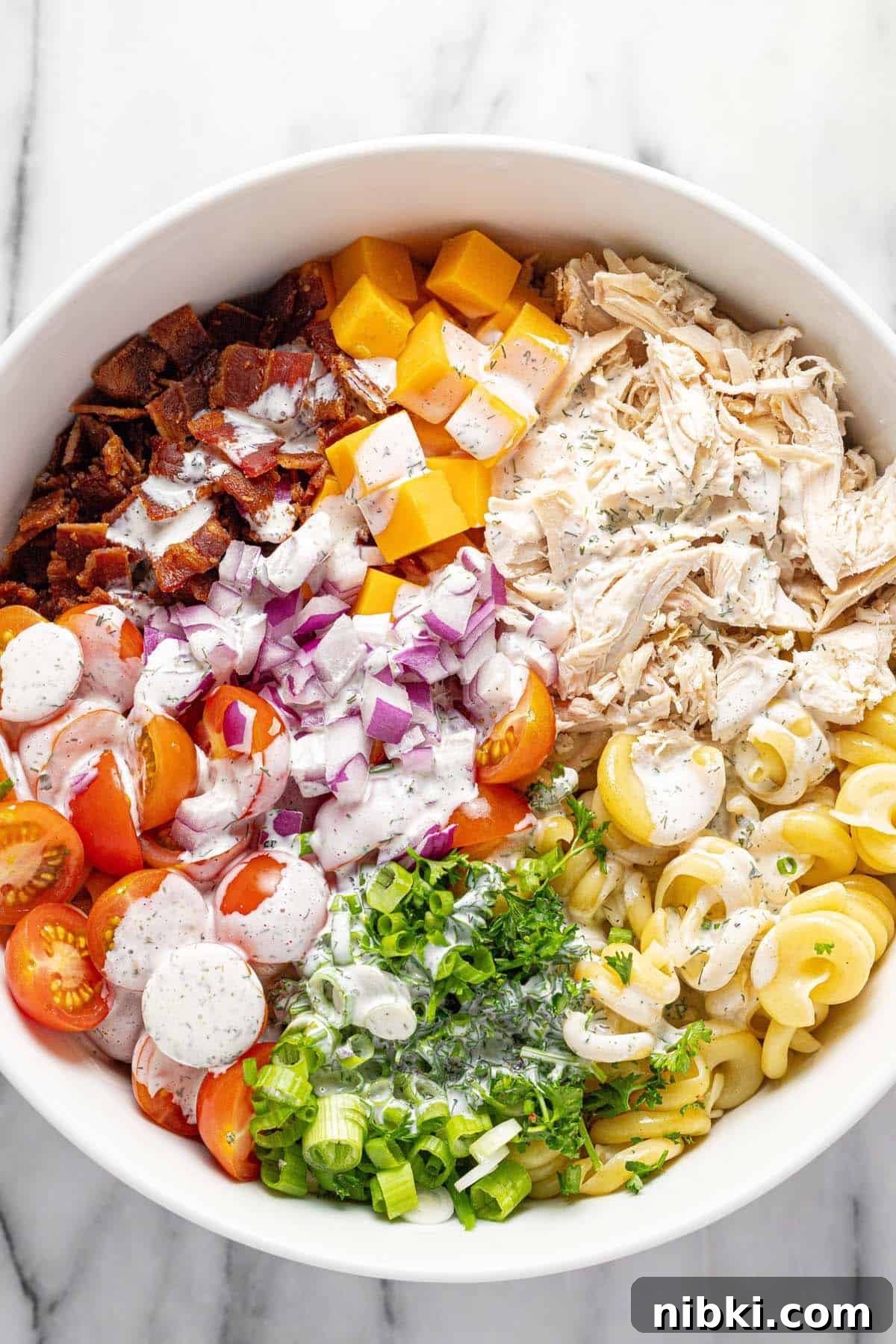 Creamy Chicken Bacon Ranch Pasta Salad Recipe 5 Ranch dressing drizzled over chicken ranch pasta salad.