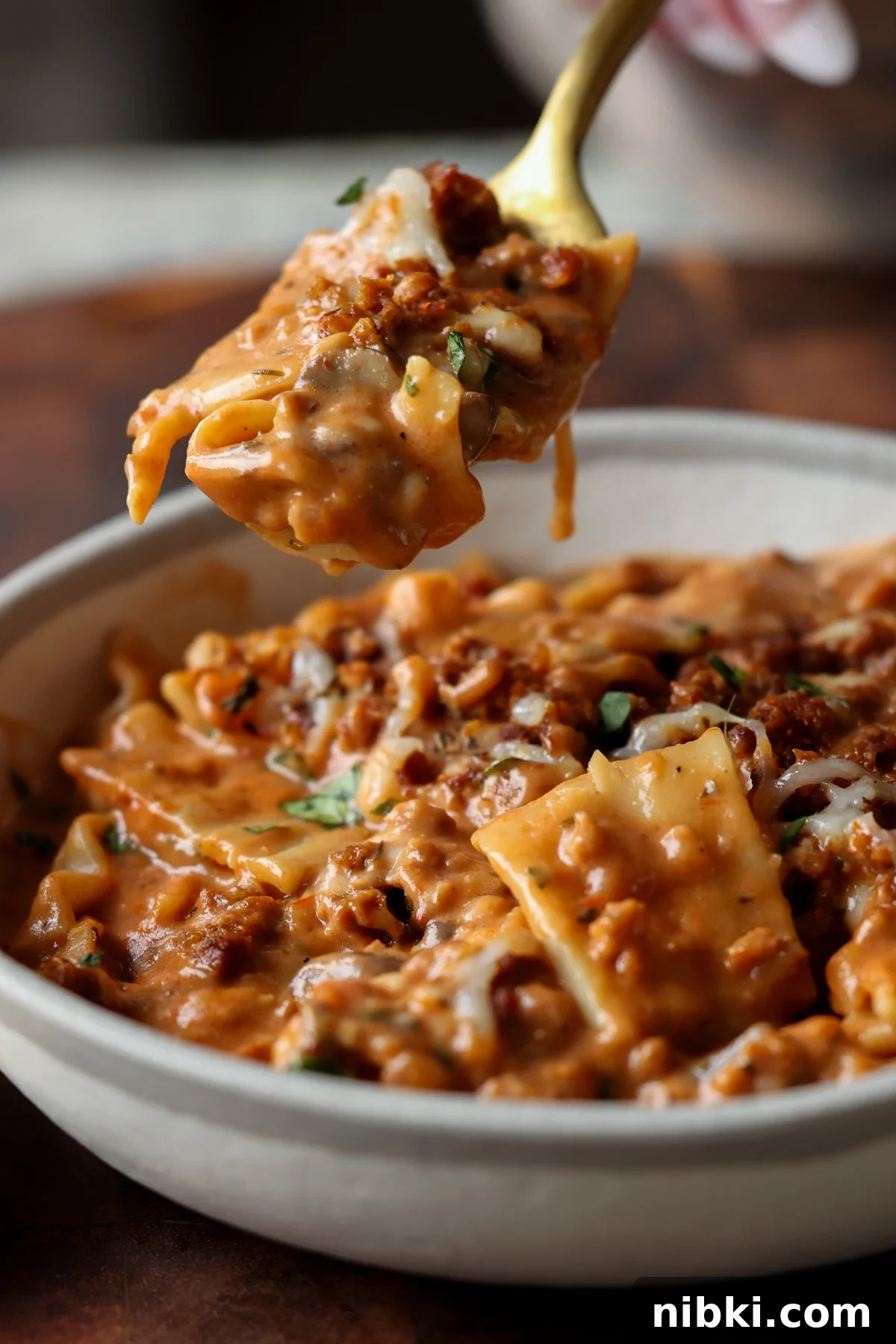 30-Minute One-Pan Creamy Lasagna Soup 2 spooning a bite of creamy lasagna soup