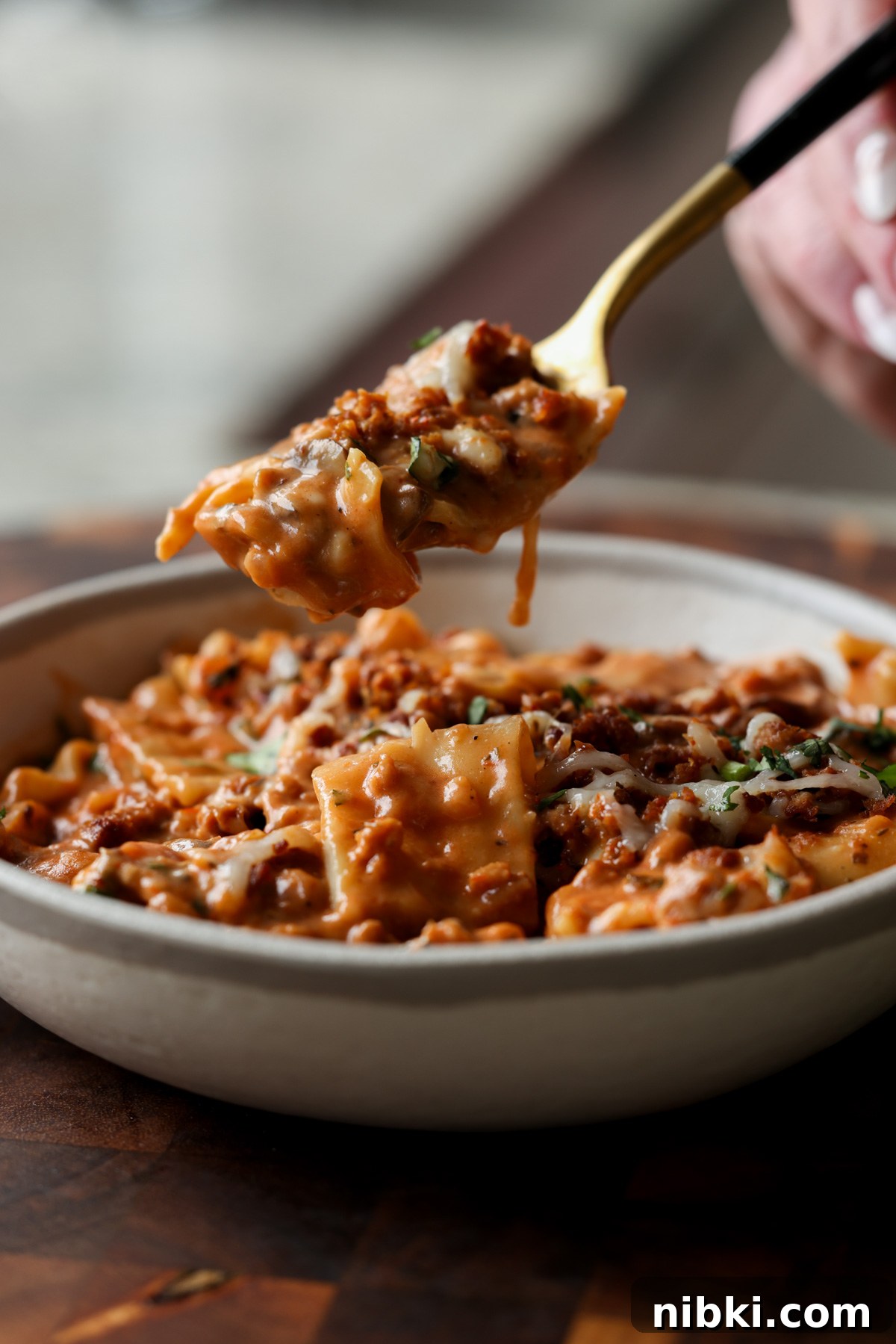 30-Minute One-Pan Creamy Lasagna Soup 10 spooning a bite of creamy lasagna soup