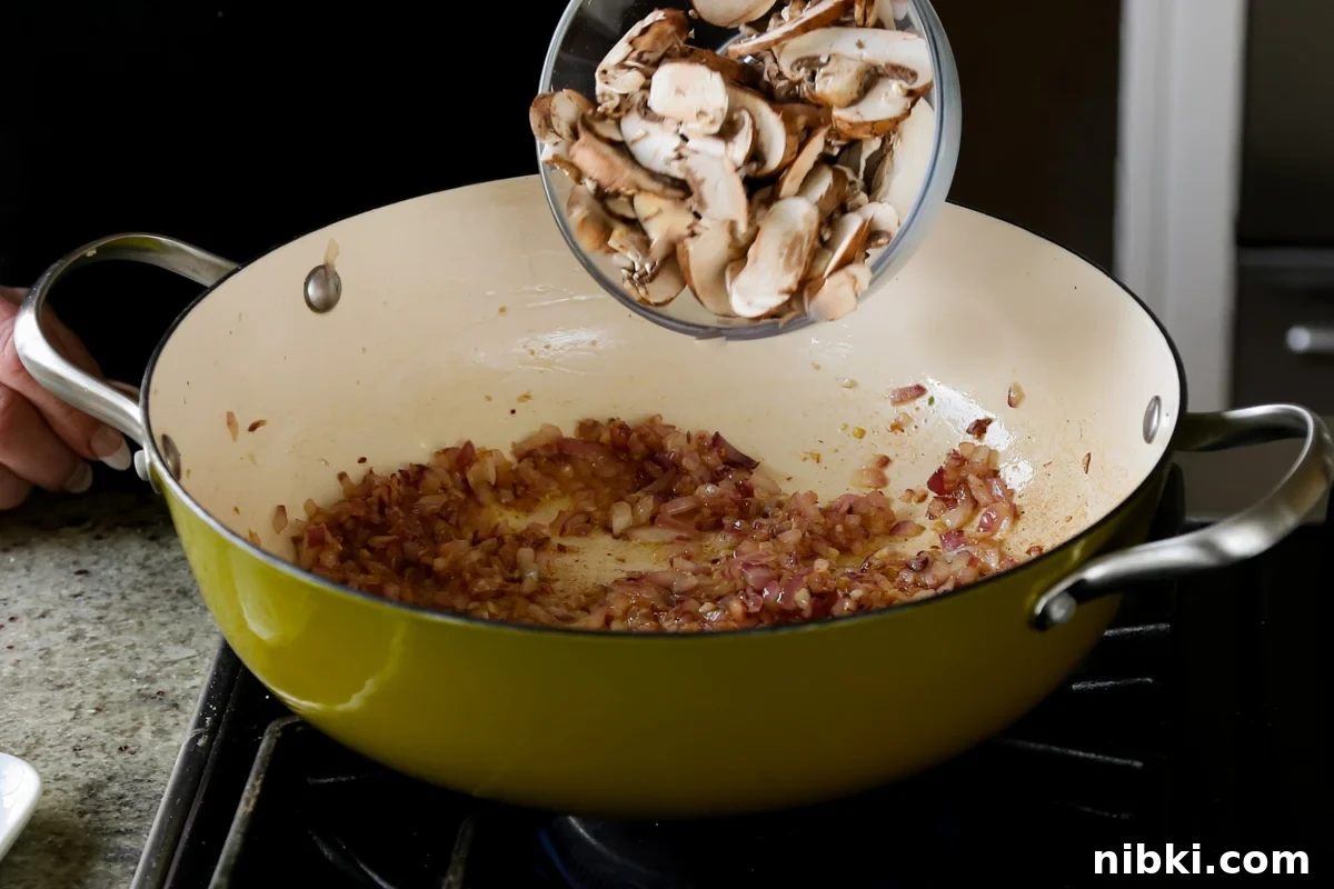30-Minute One-Pan Creamy Lasagna Soup 9 adding mushrooms to the cooked onion and garlic