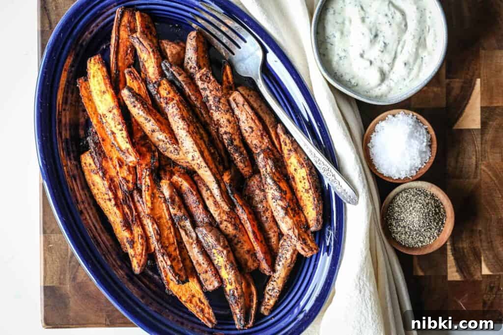 a plate full of gluten free air fryer sweet potato wedges with gluten free homemade ranch dip