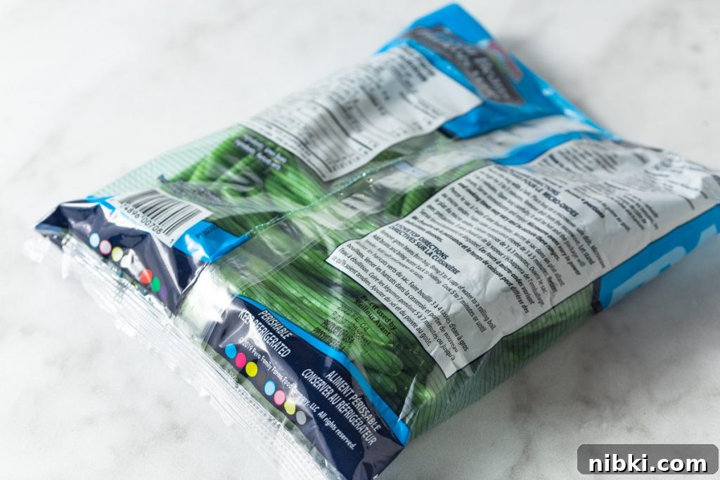 A bag of frozen green beans on a white marble counter.