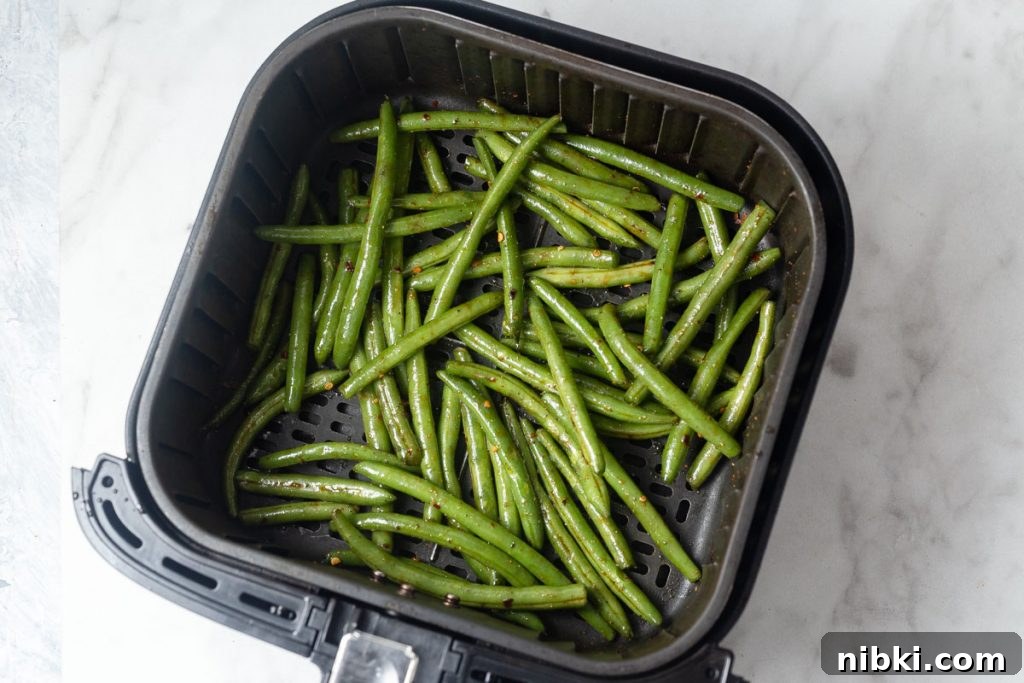 asian green beans in the air fryer basket.
