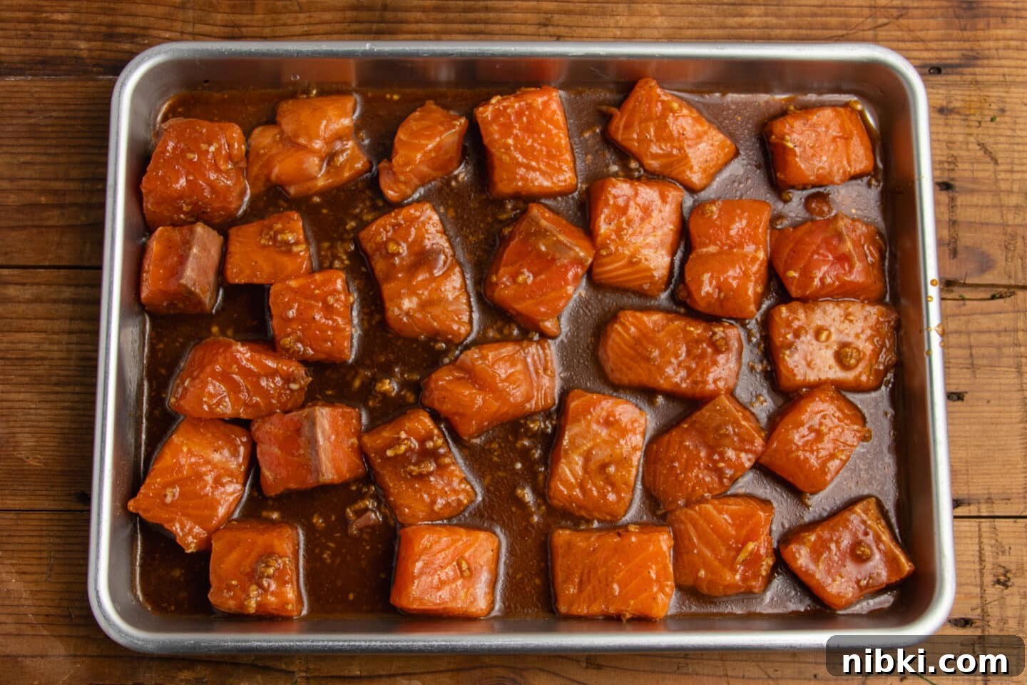 Hot Honey Garlic Salmon Bites Recipe 7 This is a picture of the salmon bites on a sheet pan before cooking.