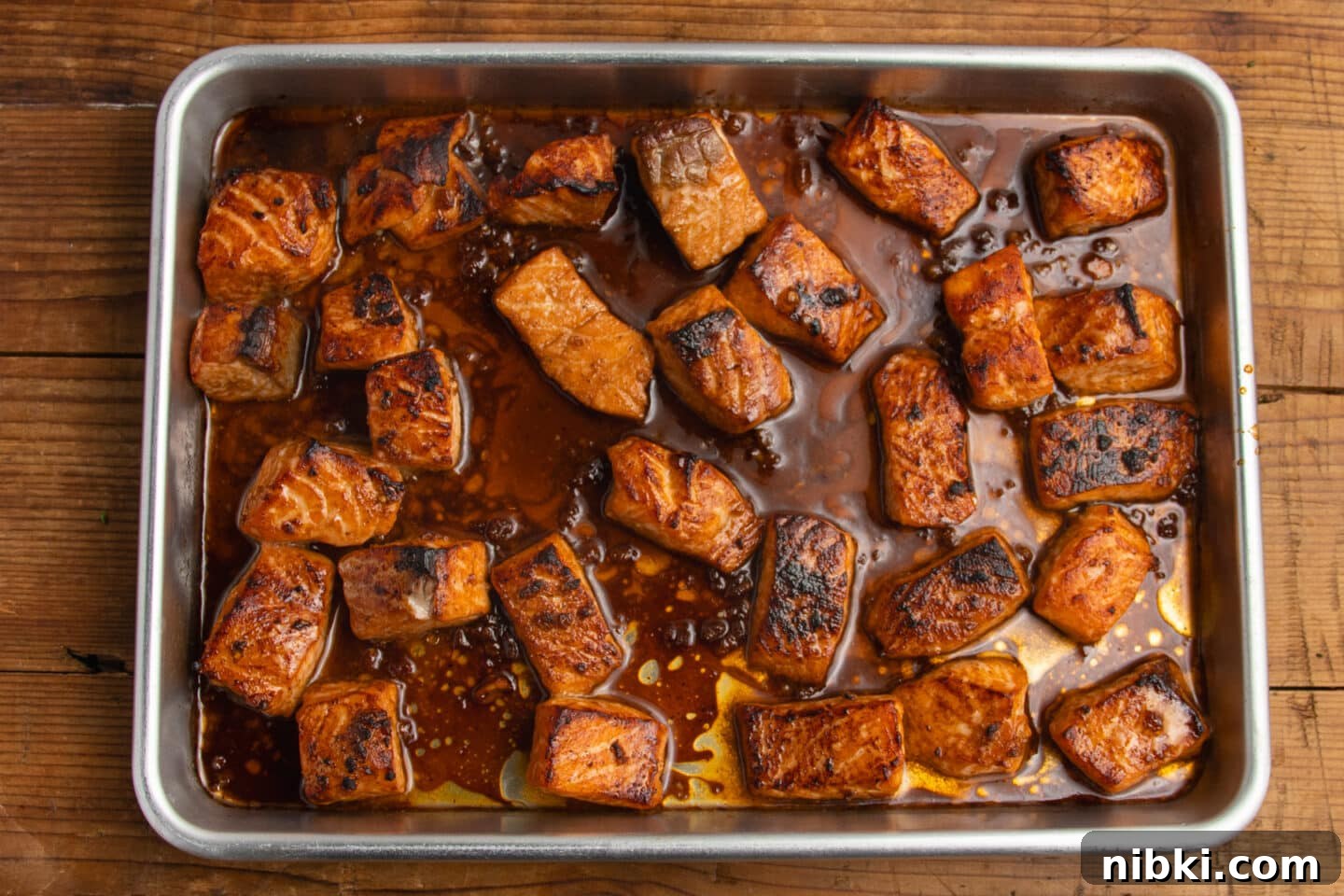 Hot Honey Garlic Salmon Bites Recipe 8 This is a picture of the salmon bites on a sheet pan after cooking.