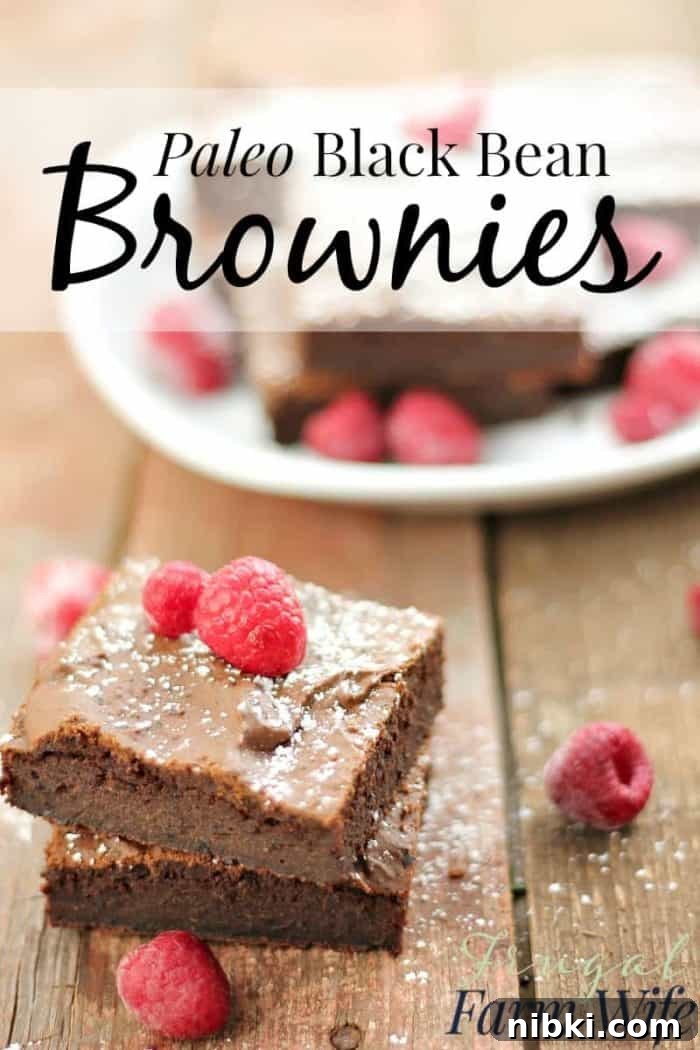 Several black bean brownies on a table with text 'Paleo Black Bean Brownies'