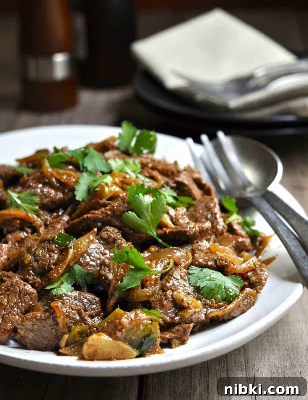 Cumin-Spiced Lamb Recipe: Tender, Flavorful Roast 2 Cumin Lamb served on a white oval platter