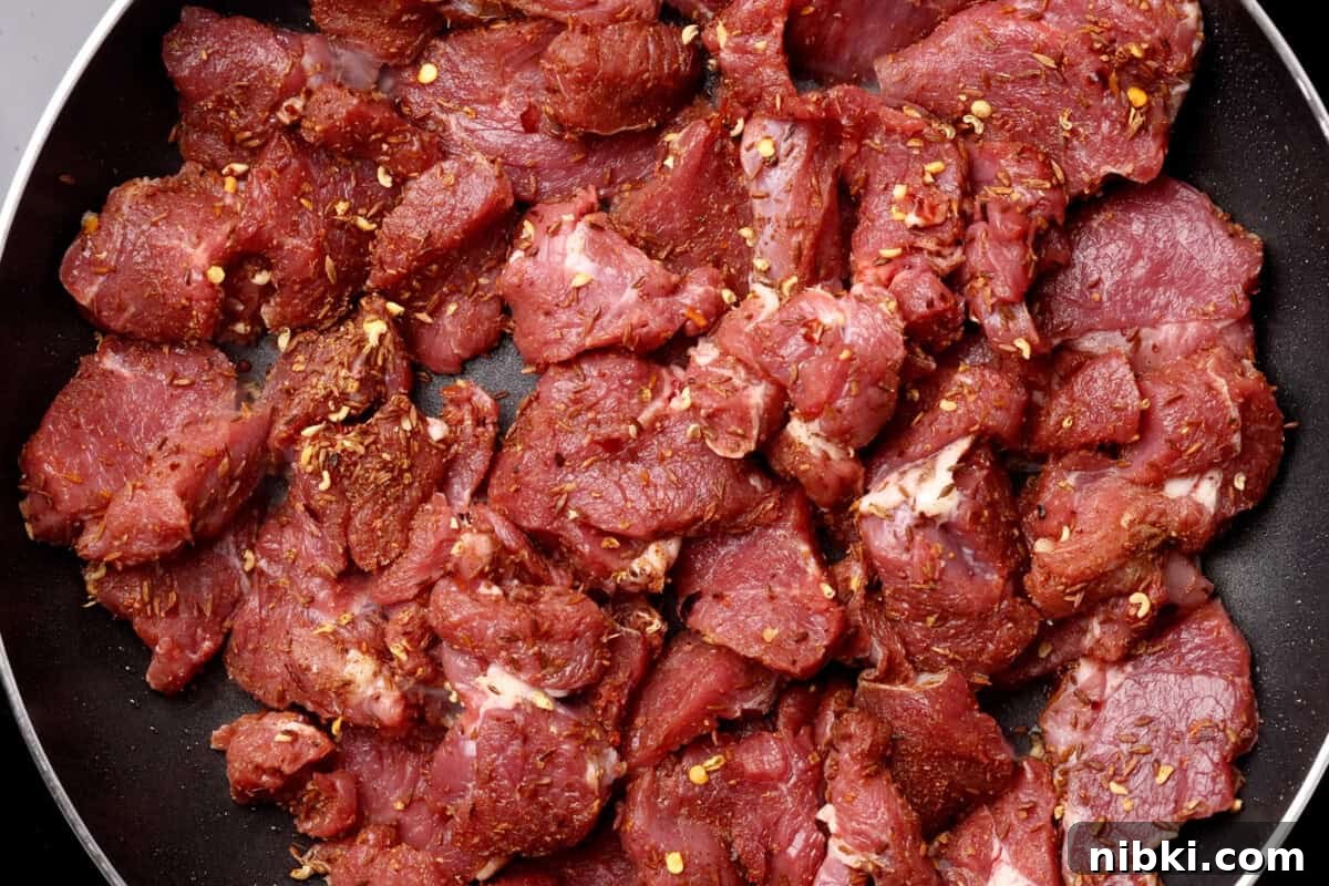 Cumin-Spiced Lamb Recipe: Tender, Flavorful Roast 7 Raw marinated meat with spices in a pan