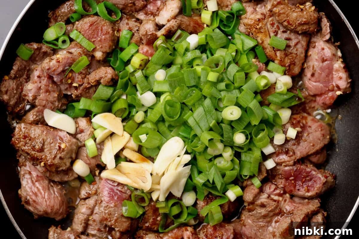 Cumin-Spiced Lamb Recipe: Tender, Flavorful Roast 8 Sliced browned meat with green onions