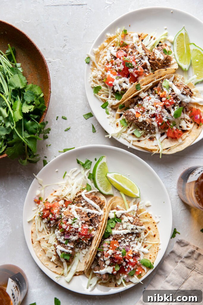 Instant Pot Barbacoa Tacos 2 instant pot beef barbacoa tacos on a plate.