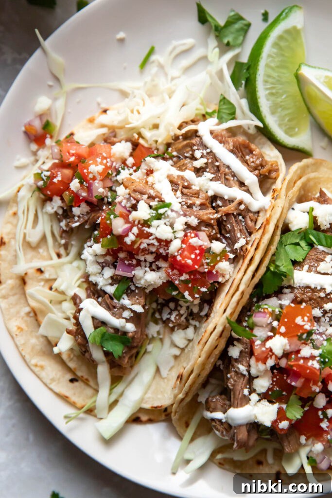 Instant Pot Barbacoa Tacos 4 instant pot beef barbacoa tacos on a plate.