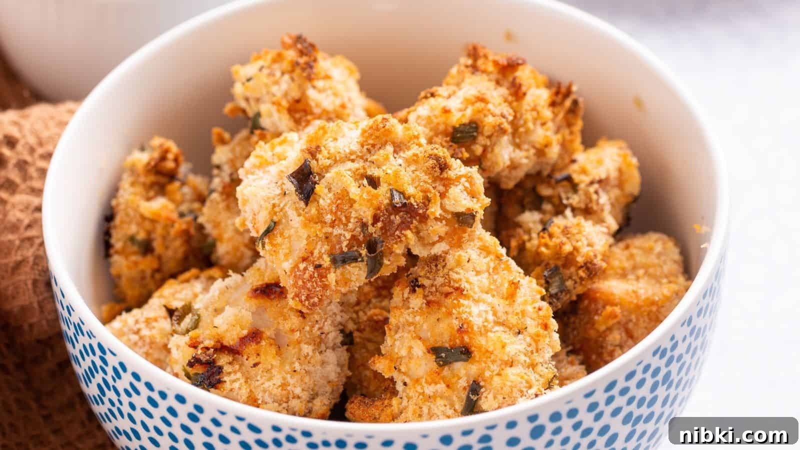 17 Affordable Chicken Recipes That Stretch Your Grocery Budget 9 A bowl of golden brown popcorn chicken on a table.