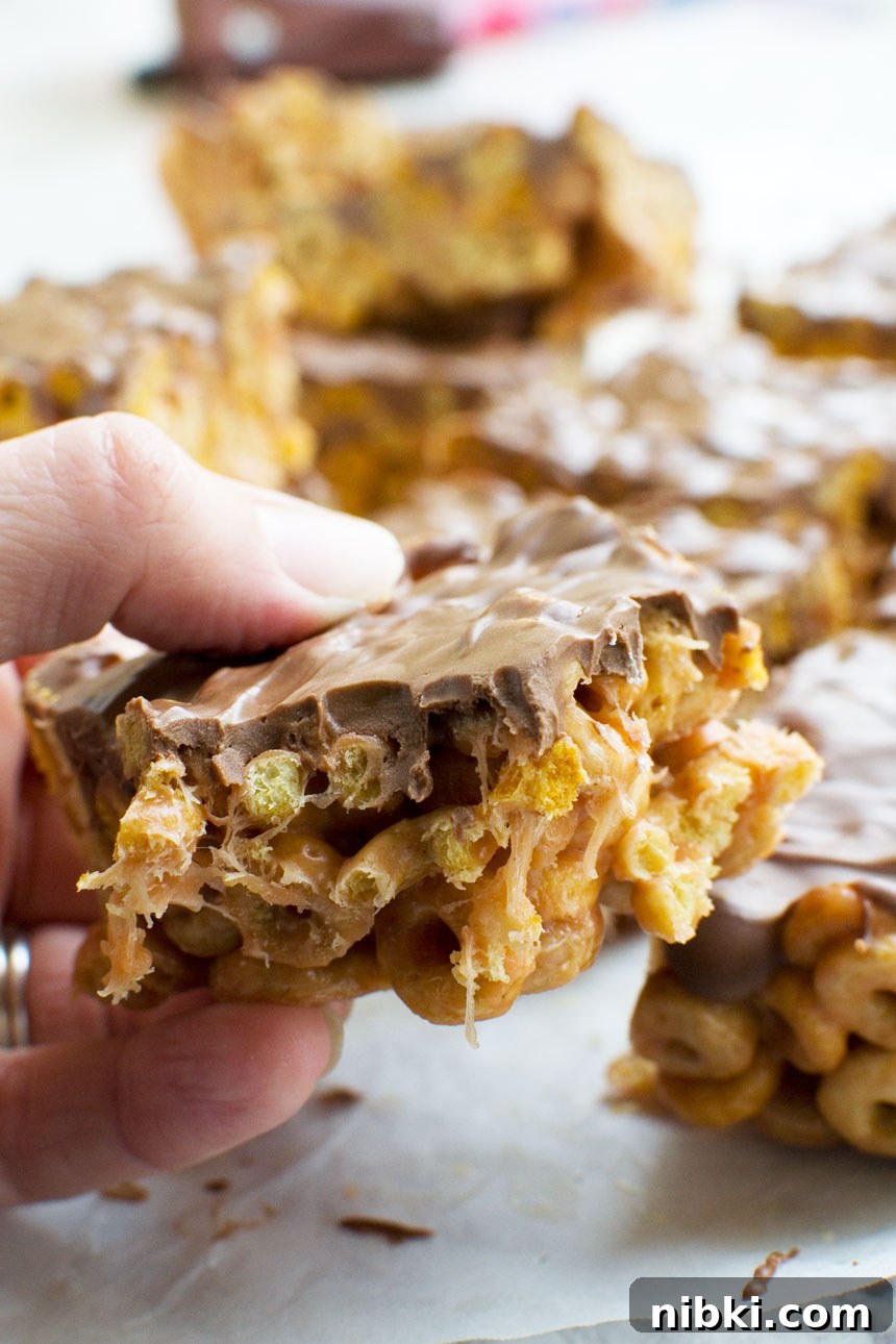 No-Bake 5-Ingredient Peanut Butter Cheerios Bars 6 Closeup of someone eating a peanut butter cheerio bar