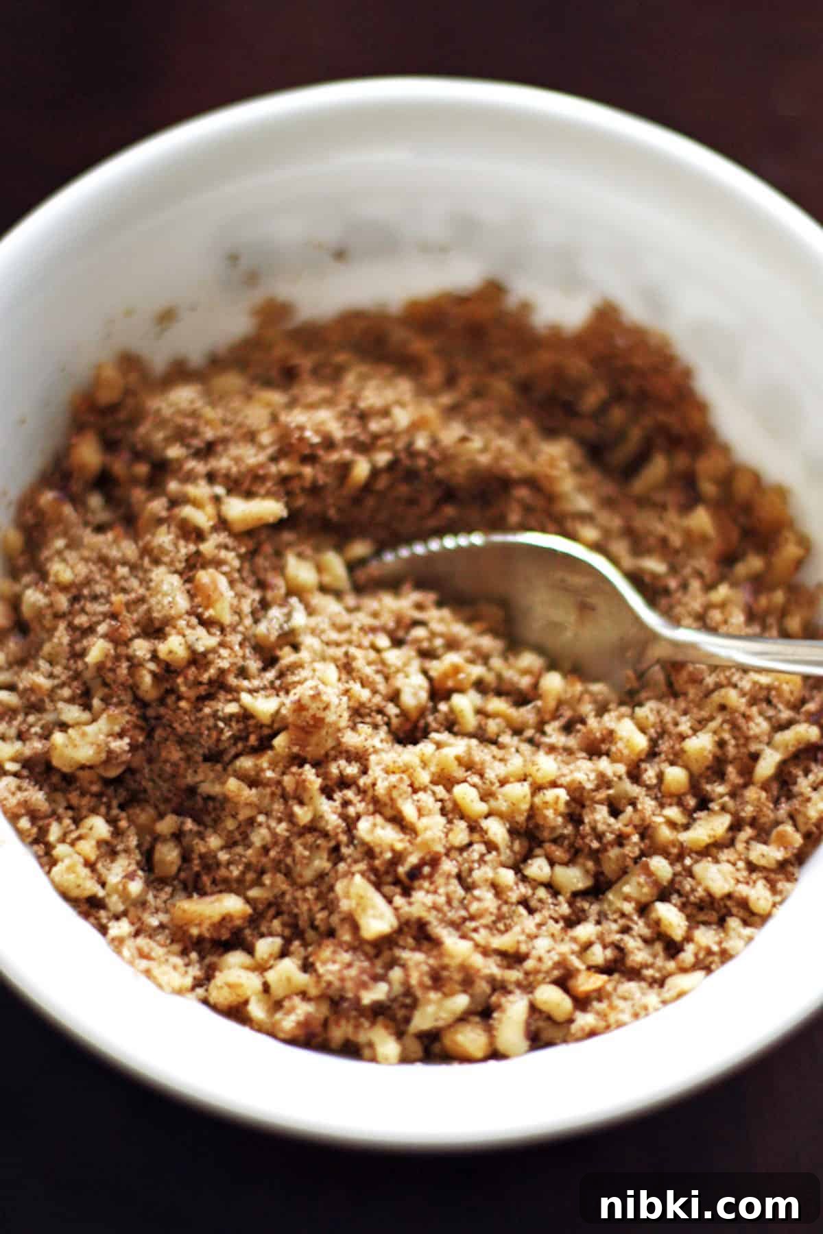 Moist Cinnamon Streusel Coffee Cake Recipe 4 A small bowl of streusel crumble made with brown sugar, walnuts, and flour.