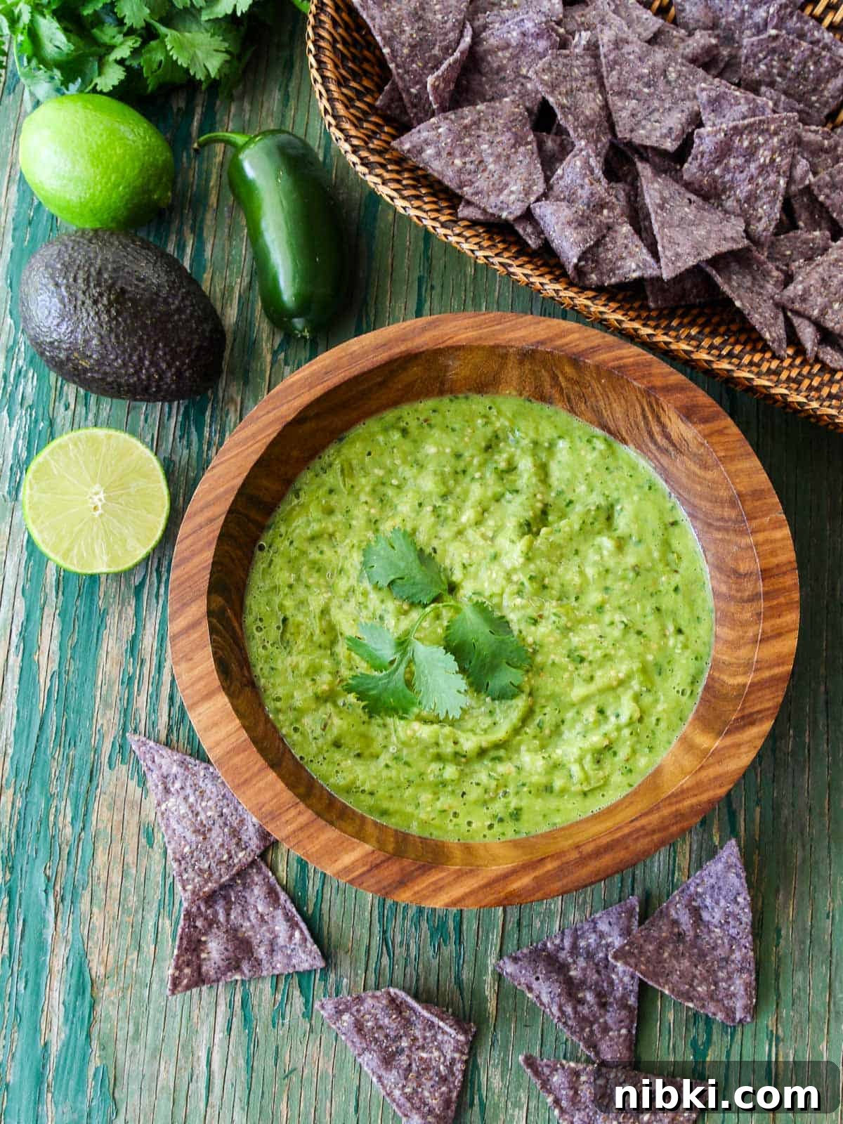 Wood bowl with Avocado Salsa and limes