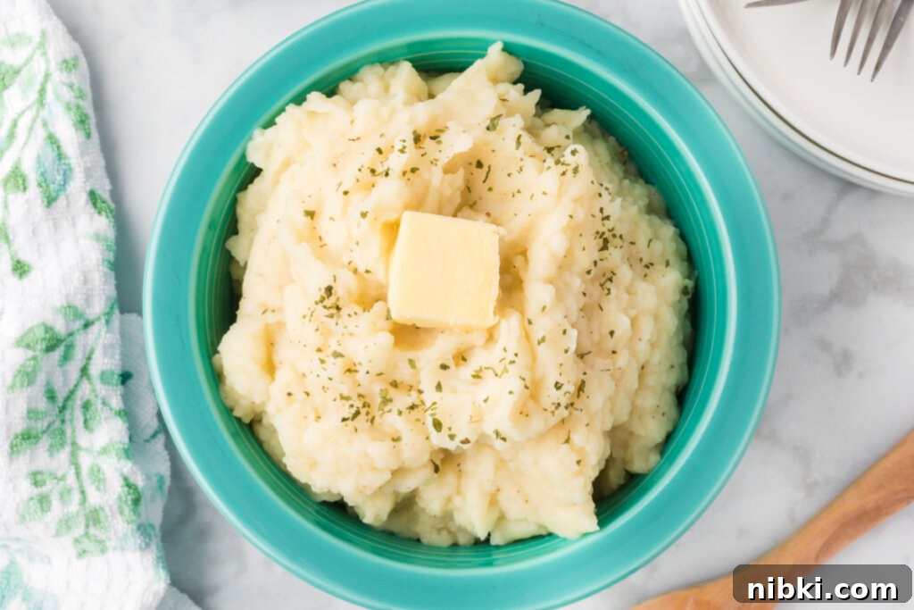 Creamy Garlic Butter Mashed Potatoes Recipe 6 mashed potatoes in aqua bowl