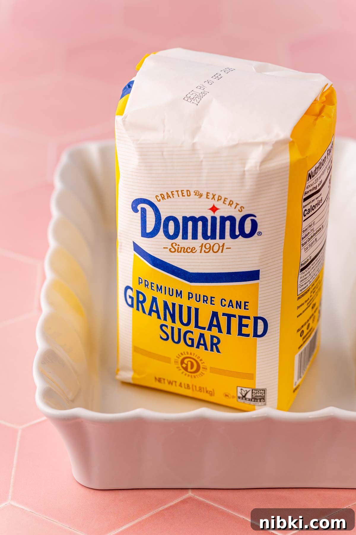 How to Make Toasted Sugar for Baking and Dessert Toppings 2 A bag of domino sugar in a white baking dish.