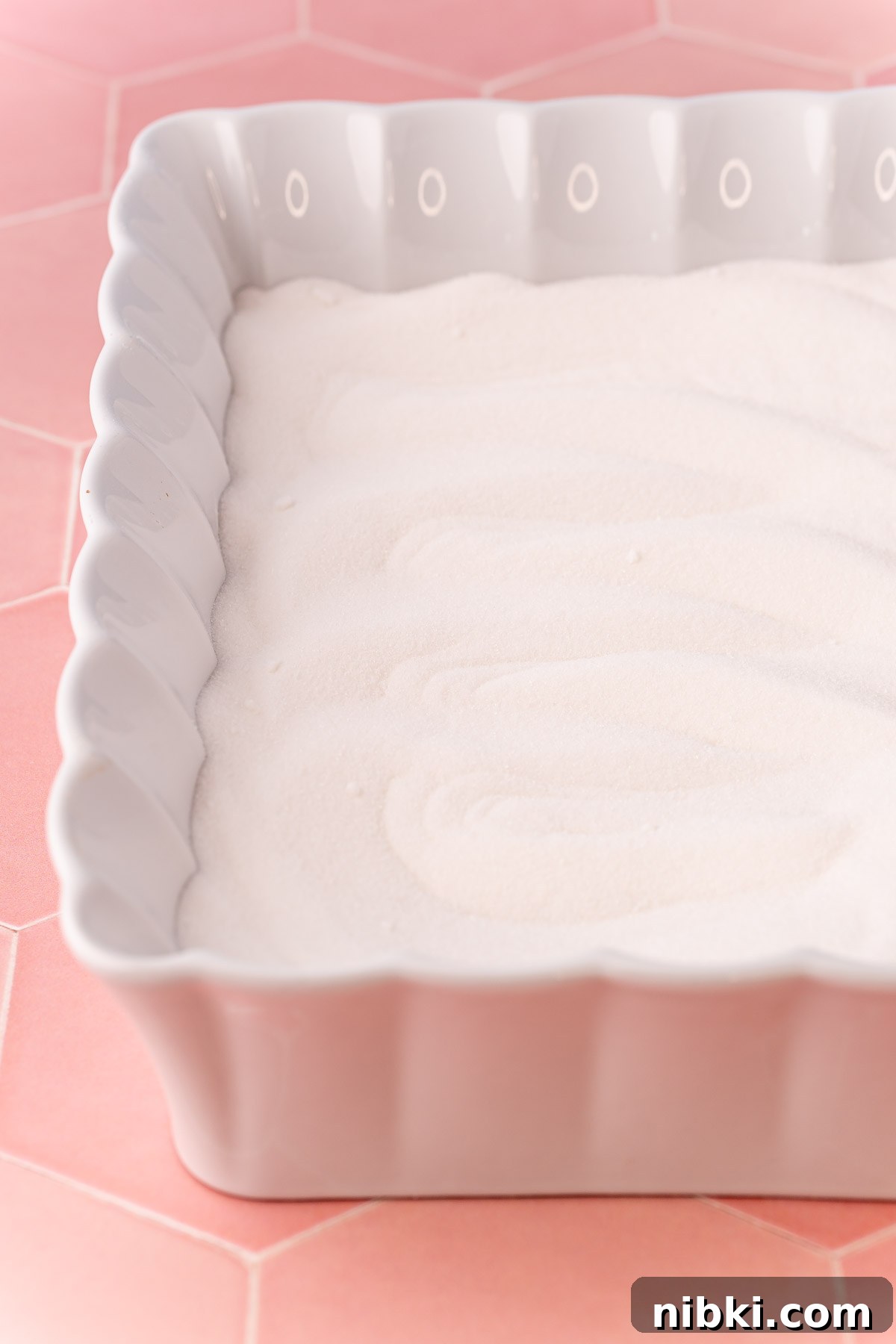 How to Make Toasted Sugar for Baking and Dessert Toppings 3 Sugar in a white ceramic baking dish.
