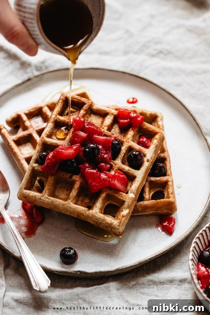 Drizzling maple syrup on top of waffles