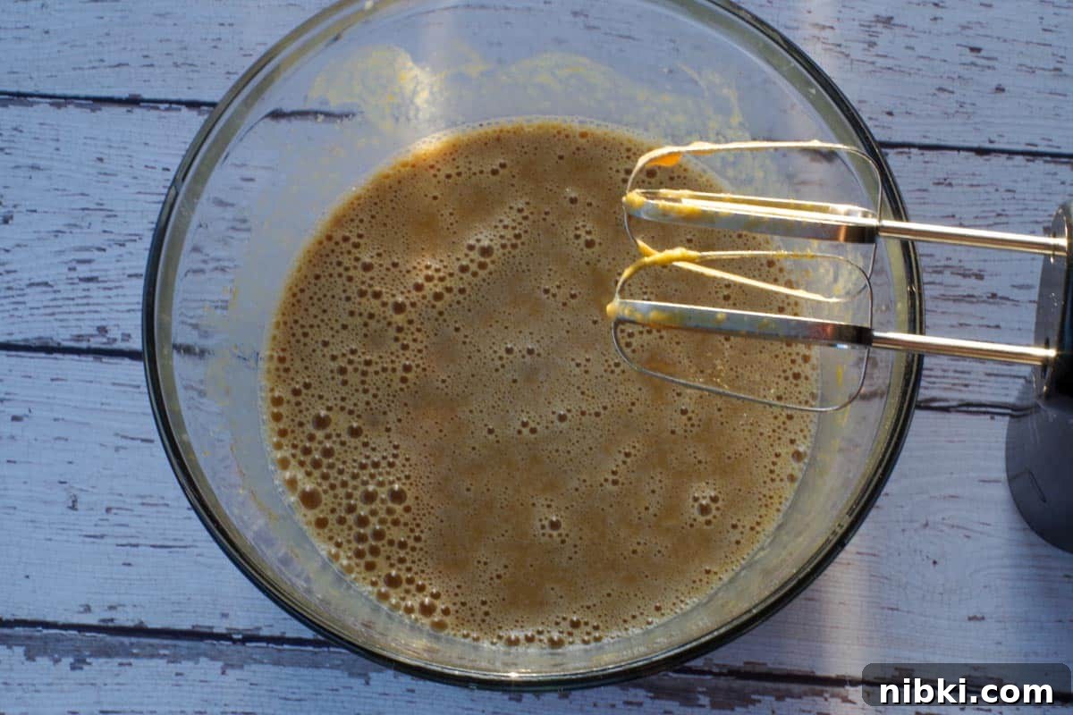 Crustless Pumpkin Pie for Weight Watchers 5 crustless pumpkin ingredients blended together in a glass bowl with beaters