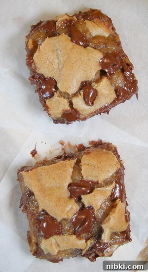 Chocolate Chip Cookie Bars are made with an easy recipe, they freeze well, and everyone loves them. Dessert squares made with chocolaty goodness, and a sweet, buttery dough.