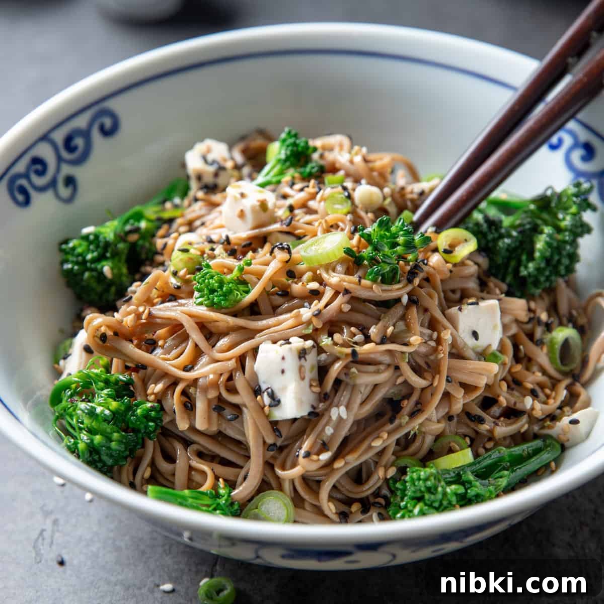 Photo showing a bowl of quick GF soba noodles with broccoli, tofu, and sesame and ginger dressing