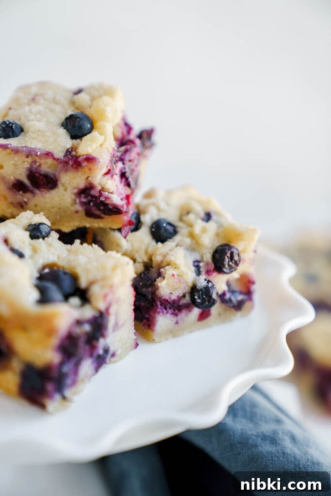 Blueberry Pie Bars with Buttery Shortbread Crust 2 Blueberry pie bars on a plate