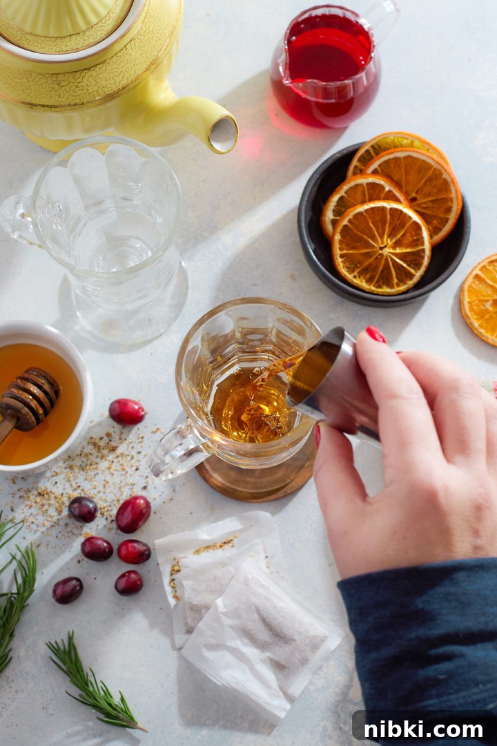 Building a hot toddy in a glass mug.