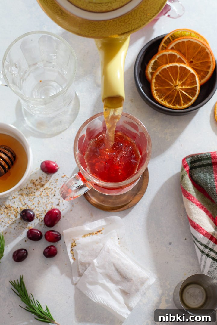 Pouring herbal tea into a hot toddy.