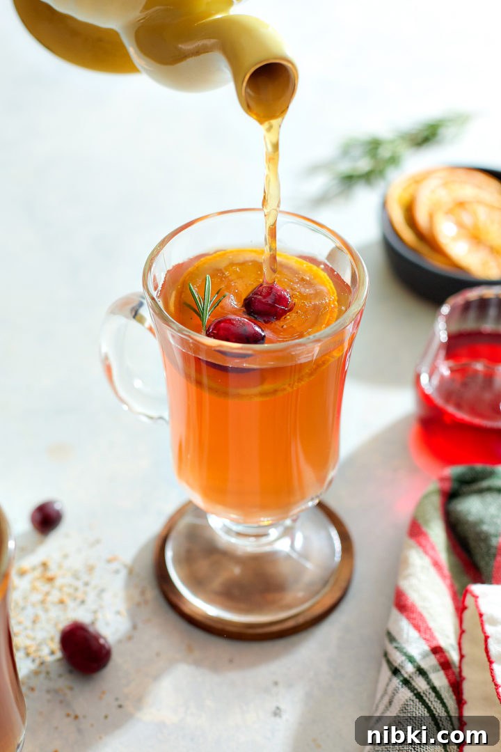 Pouring herbal tea into a hot toddy.