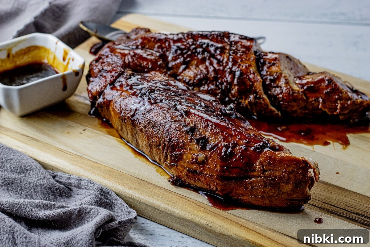 two pork tenderloins topped with a dark glaze