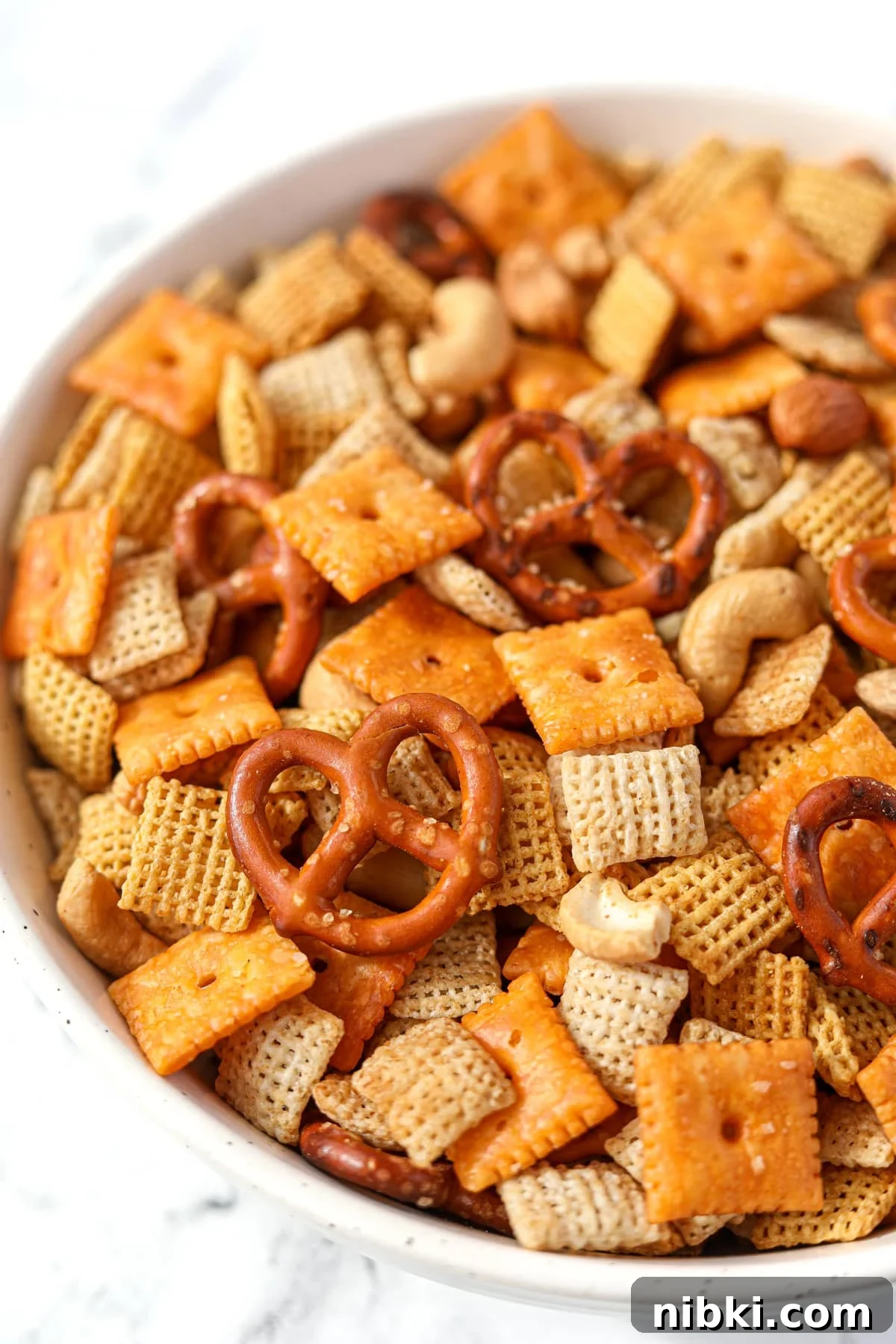 Homemade Chex Mix: Savory Snack Mix Recipe 2 A bowl of snack mix with cereal, crackers, and pretzels.