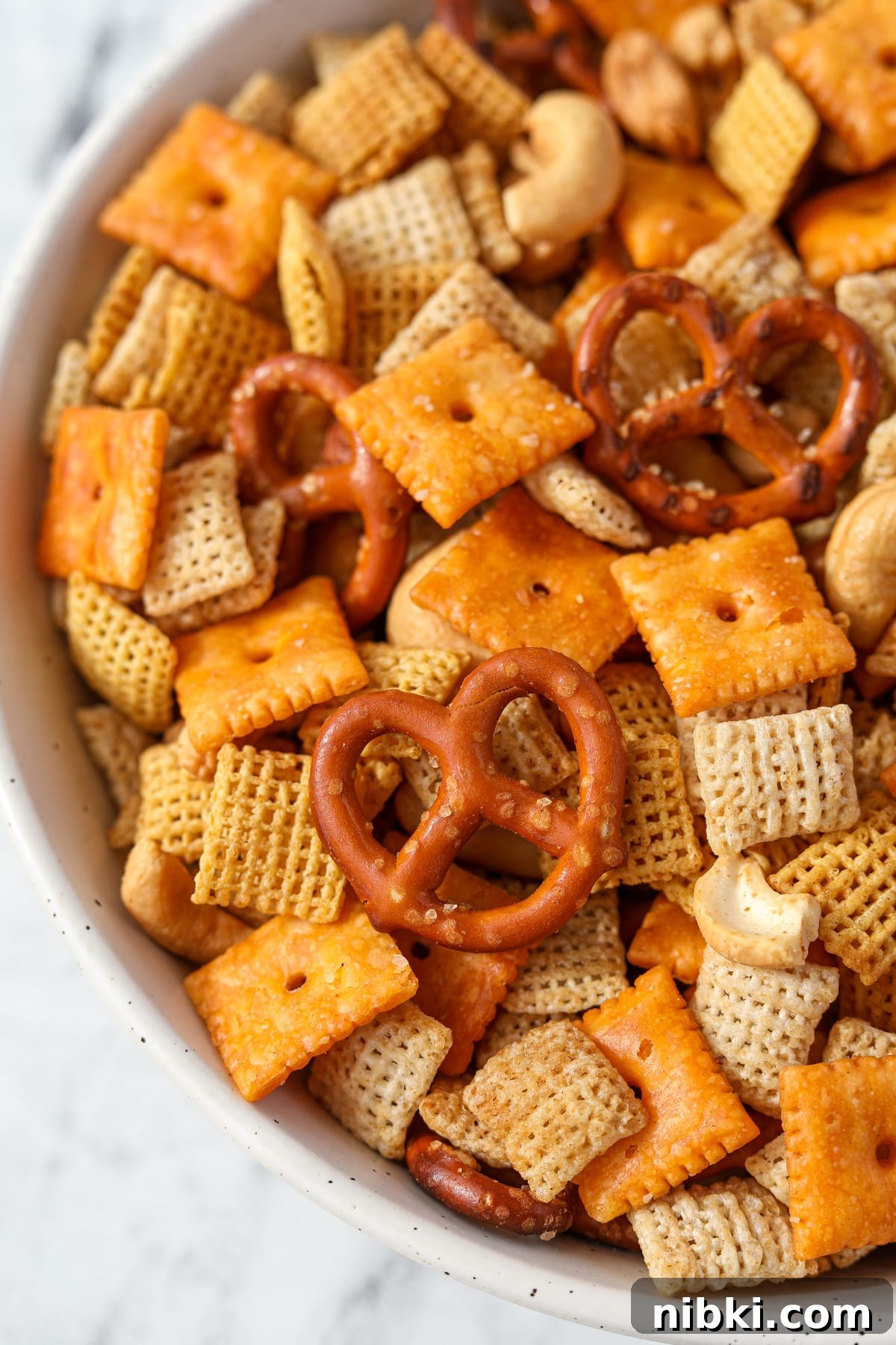 Homemade Chex Mix: Savory Snack Mix Recipe 11 A bowl of Chex Mix with pretzels, cereal, nuts, and cheese crackers.