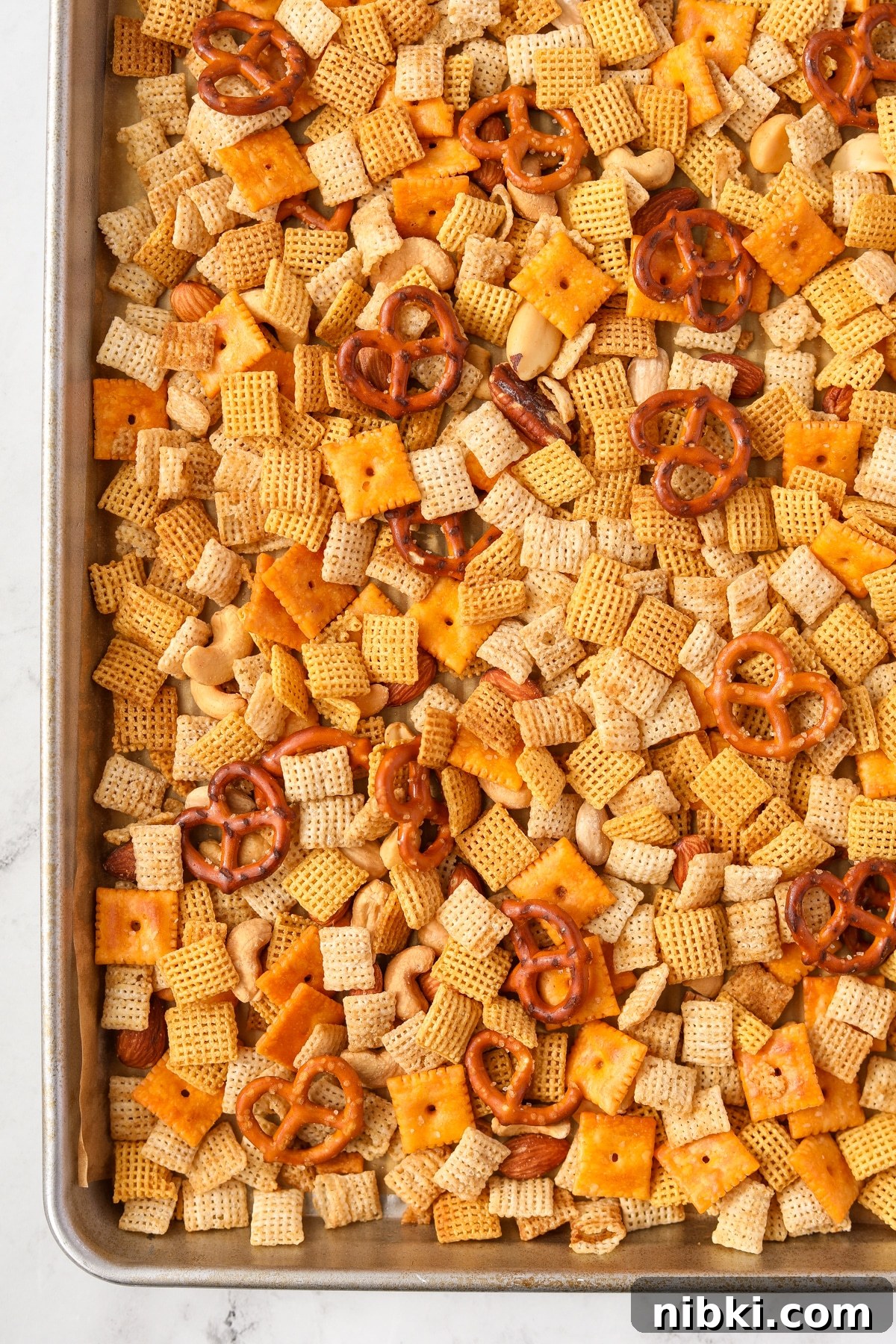 Homemade Chex Mix: Savory Snack Mix Recipe 12 A baking sheet filled with chex mix.