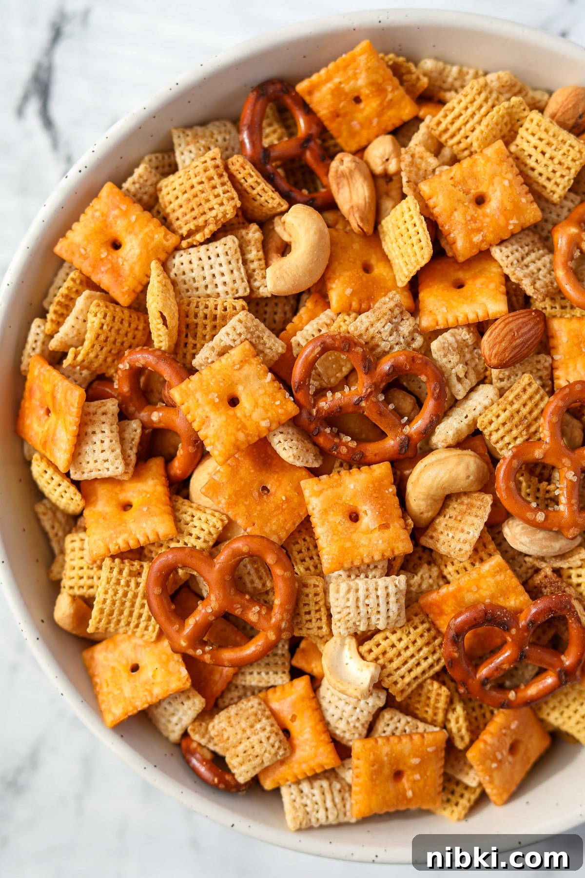 Homemade Chex Mix: Savory Snack Mix Recipe 13 An overhead view of a bowl of snack mix with pretzels, crackers, cereal, and nuts.