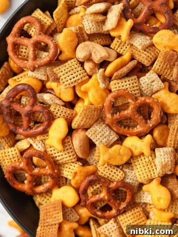 Homemade Chex Mix: Savory Snack Mix Recipe 14 A bowl of Chex Mix with pretzels, cereal, nuts, and cheese crackers.