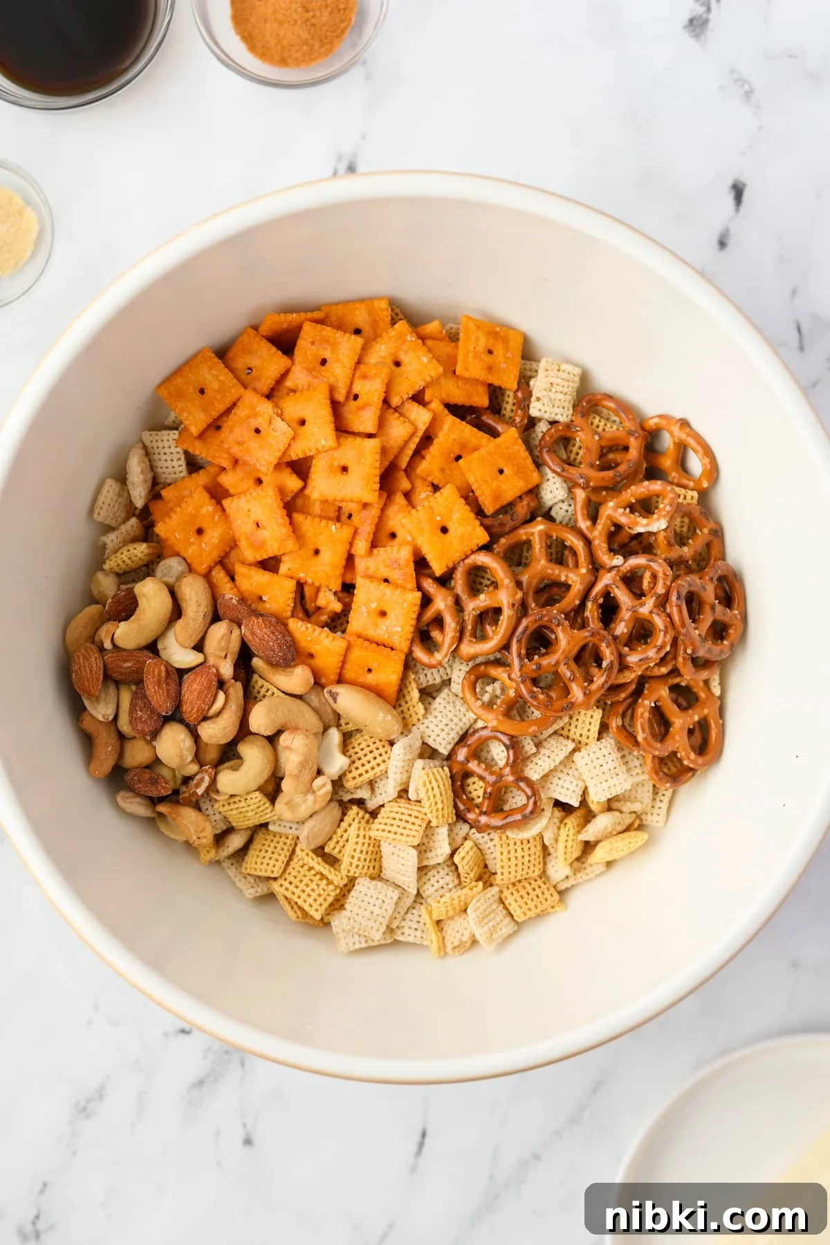 Homemade Chex Mix: Savory Snack Mix Recipe 4 A bowl with cheese crackers, Chex mix, pretzels, and mixed nuts.