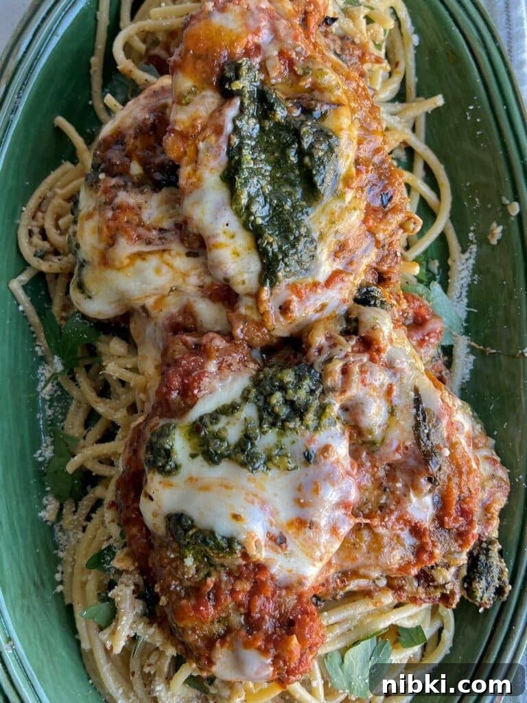 Skillet Chicken Parmesan with Pesto 2 Chicken parm with pesto in green platter.
