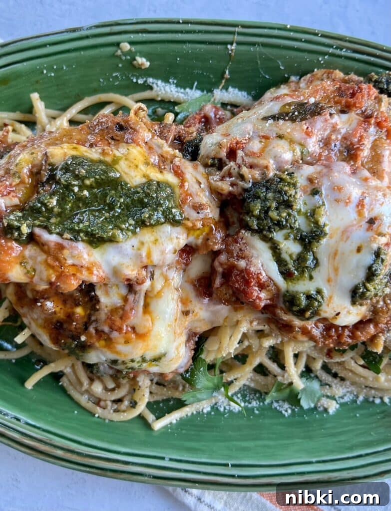 Skillet Chicken Parmesan with Pesto 12 Chicken parm with pesto in green platter.