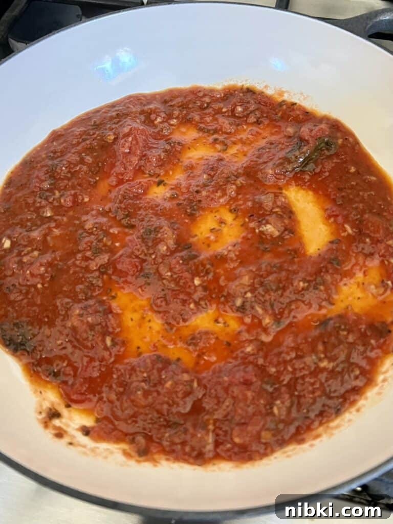 Skillet Chicken Parmesan with Pesto 5 Tomato Sauce on bottom of pan.