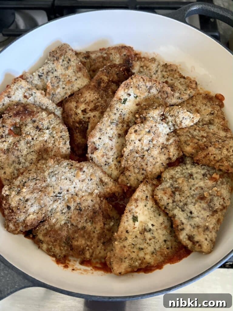 Skillet Chicken Parmesan with Pesto 6 Chicken cutlets layered on top of marinara sauce.