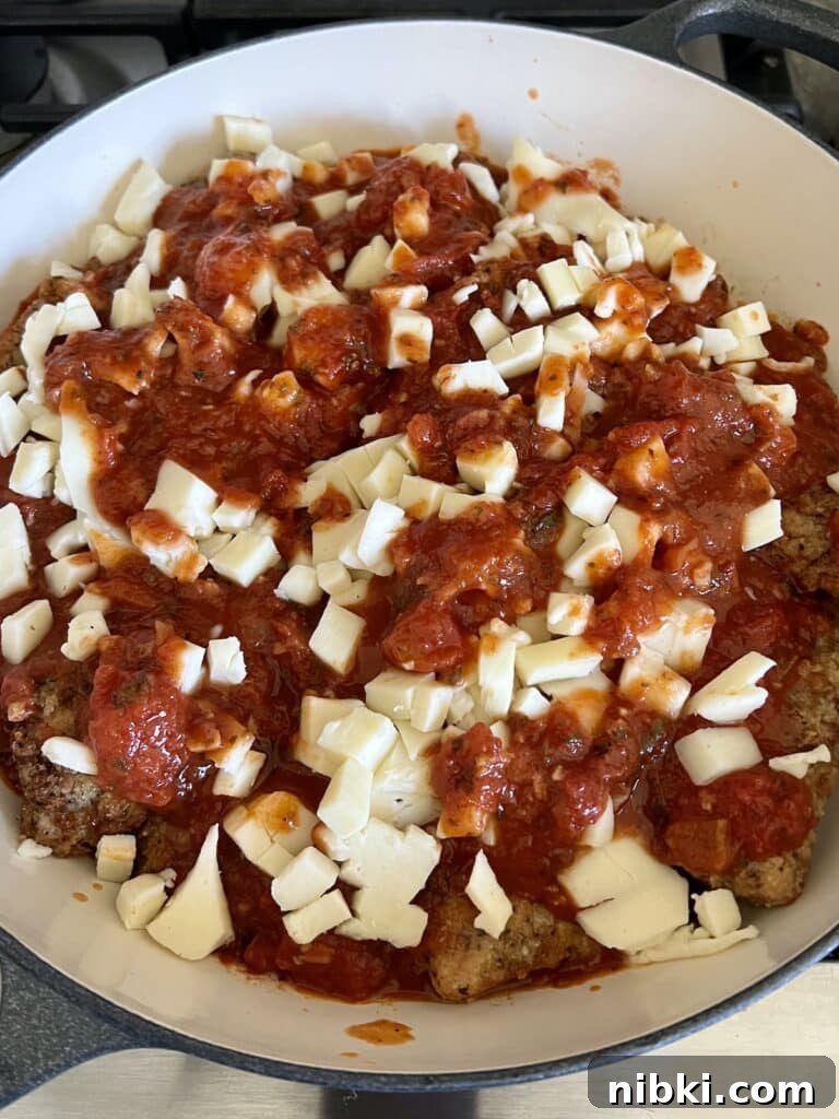 Skillet Chicken Parmesan with Pesto 8 Mozzarella sprinkled over marinara sauce.