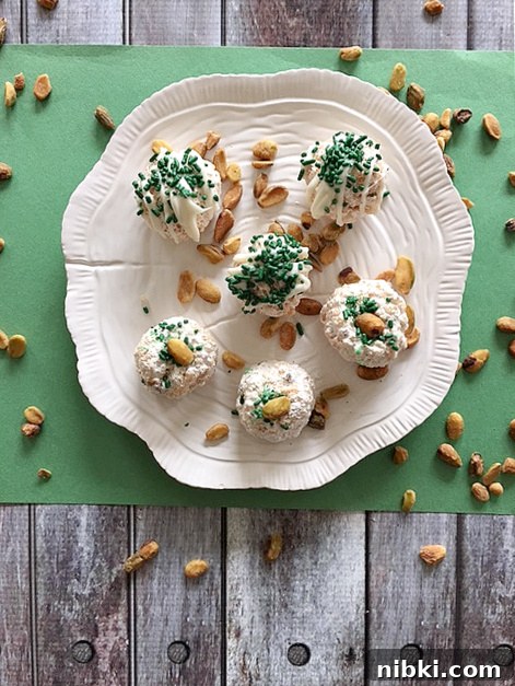No-Bake Pistachio Marshmallow Crunch Bites 2 Pistachio marshmallow crunch balls on a plate