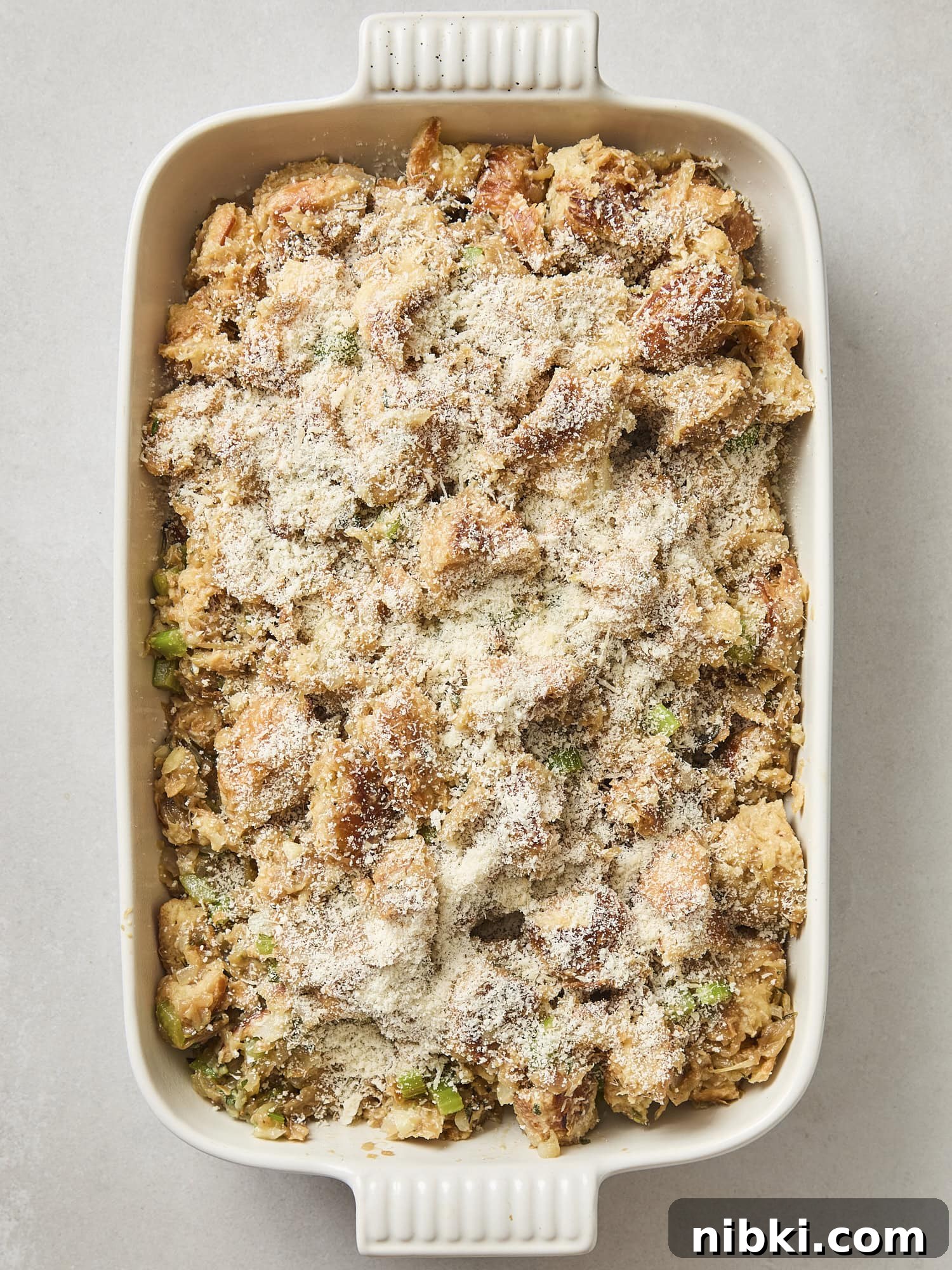 Caramelized Onion and Croissant Stuffing Recipe 12 Unbaked croissant stuffing with fresh Parmesan cheese on top.
