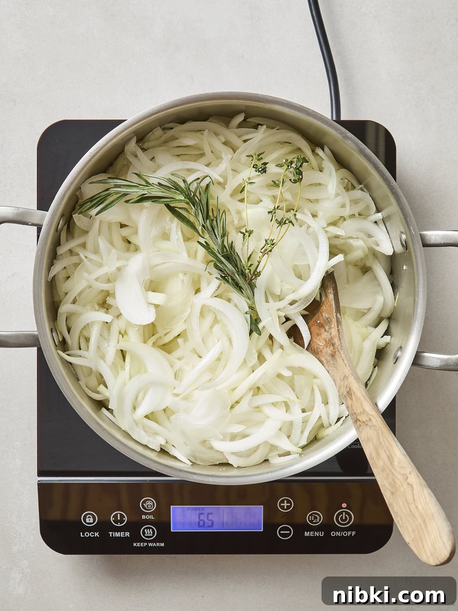 Caramelized Onion and Croissant Stuffing Recipe 6 Raw sliced vegetables with herbs in a pot before cooking.